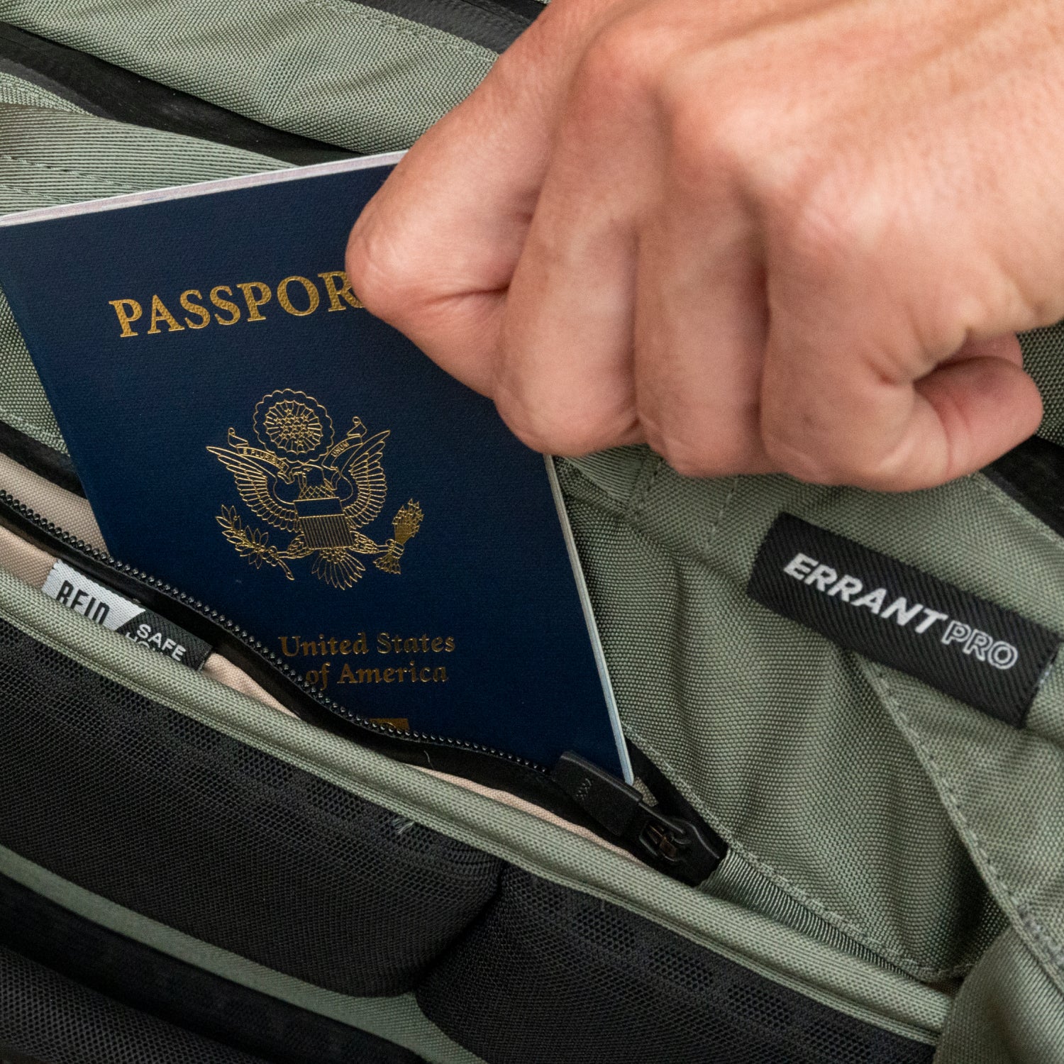 A man slides his passport into his Errant Pro travel backpack.