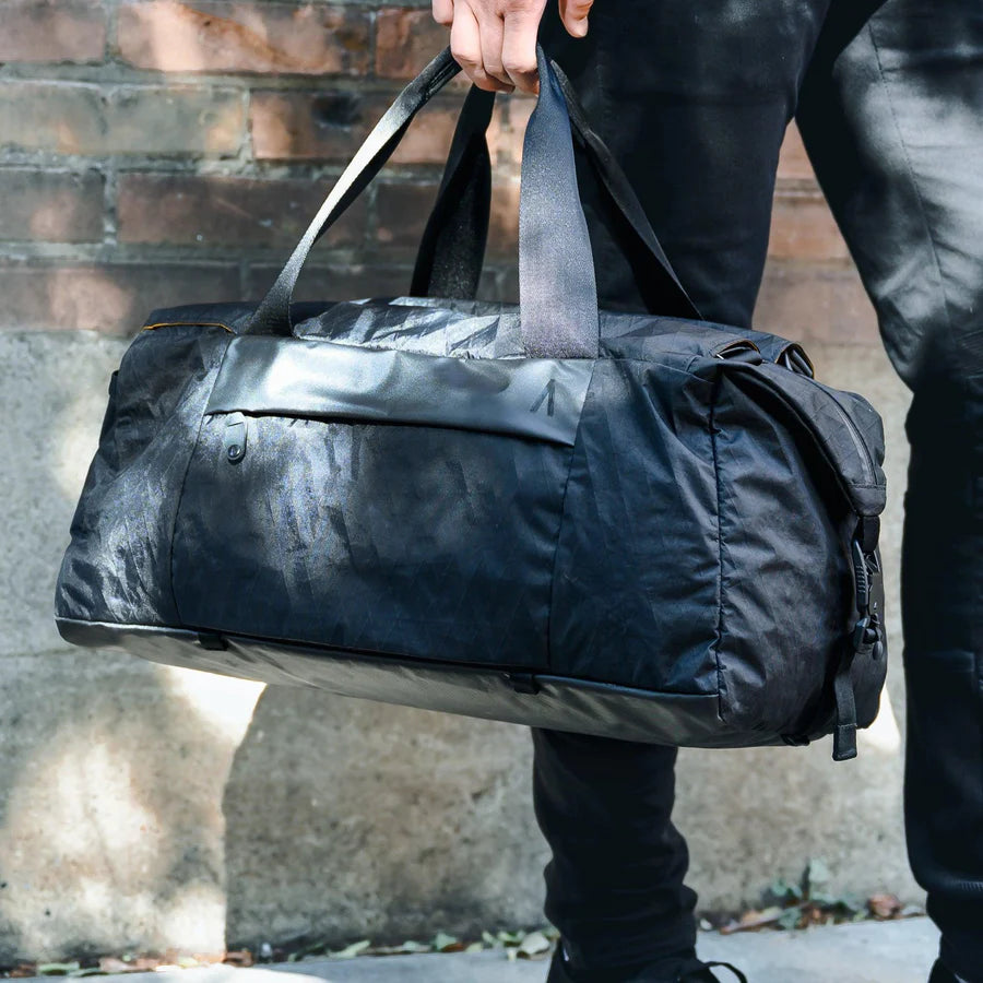 A man carrying his water-resistant Duffel X-Pac