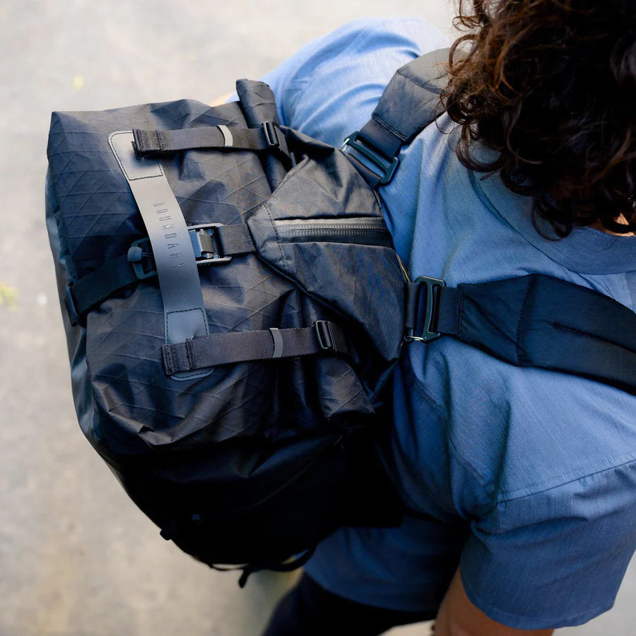 An overhead view of an individual with their Aegis Duffle X-Pac strapped to their back.