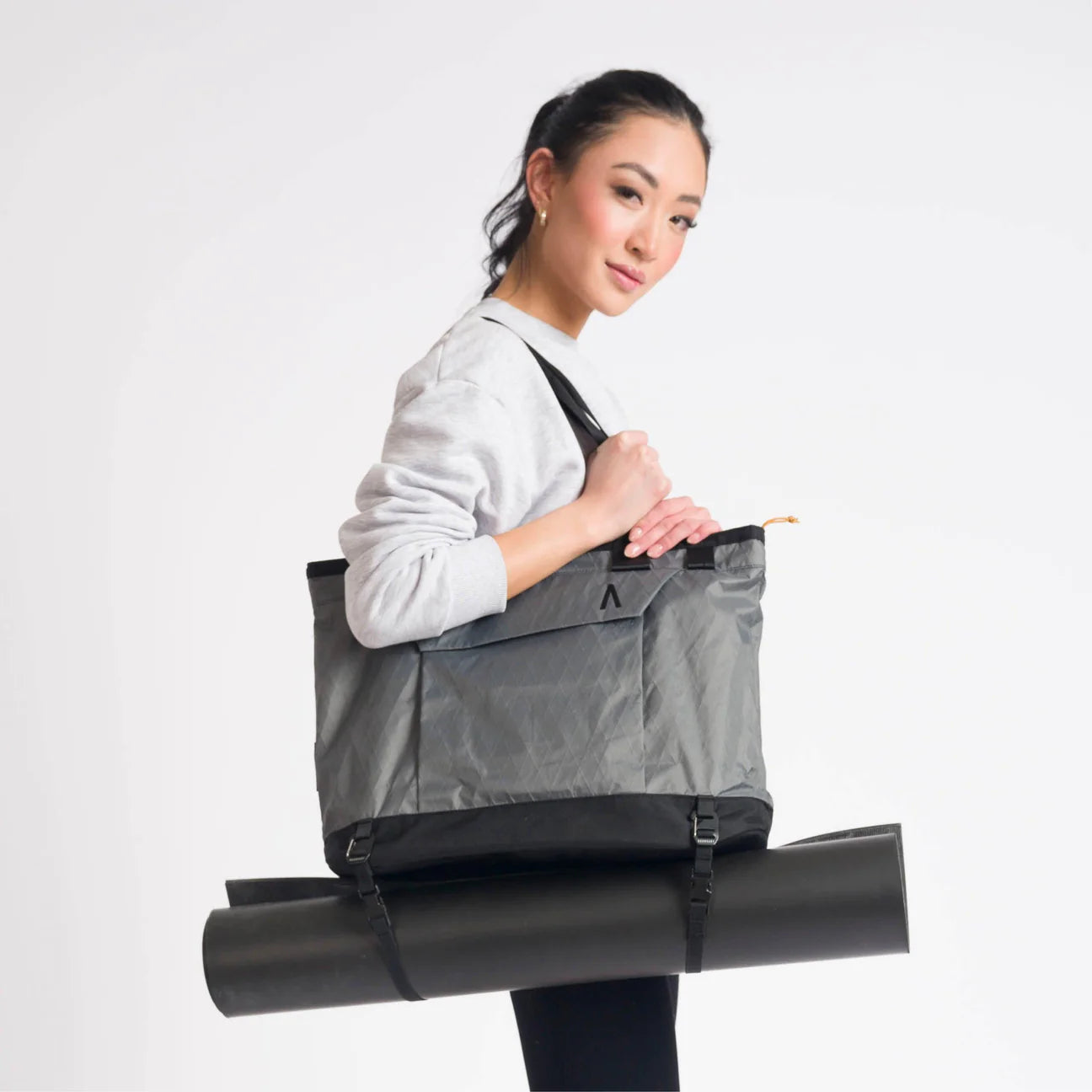 A woman holding the Rennen Tote Bag X-Pac.