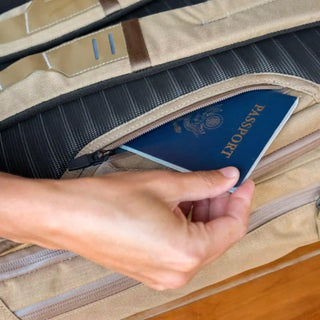A woman pulls out her passport from her Errant Pack.